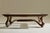 A striking contemporary sculptural coffee or center table featuring a richly stained walnut form with an inset glass top,...
