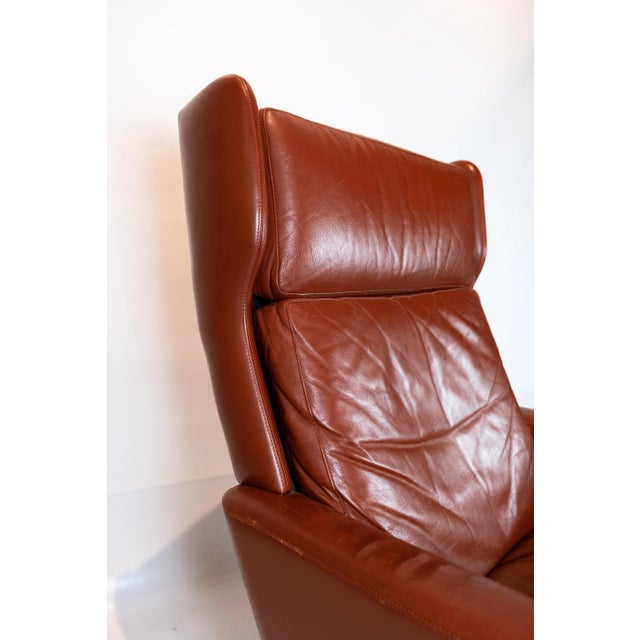 Easy chair upholstered with red brown elegance leather of Danish design from the 1970s. The chair is in great vintage...