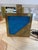 Italian table lamp featuring a rectangular brass base with a striking blue lacquered glass panel set into the front face,...