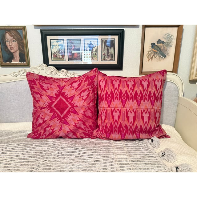 Beautiful set of two handcrafted pillow covers featuring a vibrant pink, orange, and magenta Ikat pattern. Made in Vietnam...