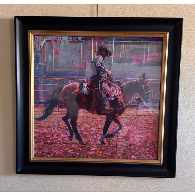 This artwork captures a dynamic moment of a cowboy on horseback, skillfully handling a pink rope amidst a vibrant,...
