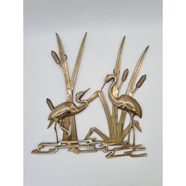 A striking wall decoration made of solid brass, depicting two herons among the reeds by the water’s edge. The piece...
