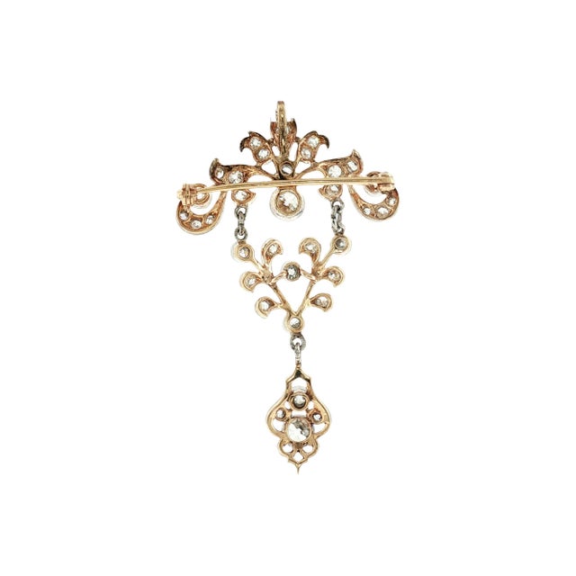 An Edwardian pendant crafted from platinum over 14k yellow gold. The design features 34 old mine-cut diamonds with an...