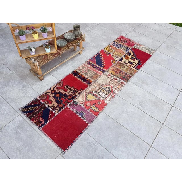 This is a vintage Turkish Oushak rug from the Mid 20th Century. The piece was hand-knotted.