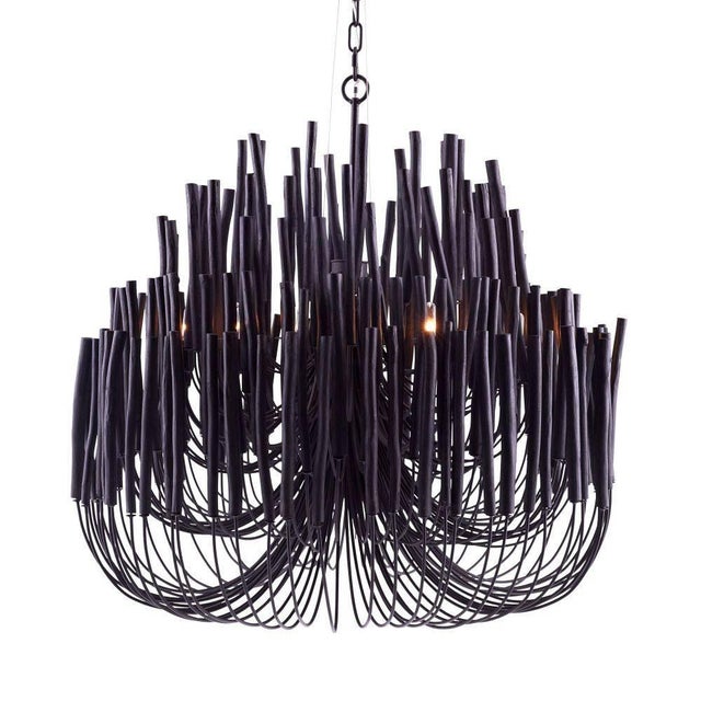 This rustically refined chandelier instantly transforms a space. The multi-tiered form features wooden dowels, finished in...