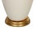 A ceramic lamp in a lovely cream-colored glaze with a graceful silhouette. The warm giltwood base gives the lamp a soft...