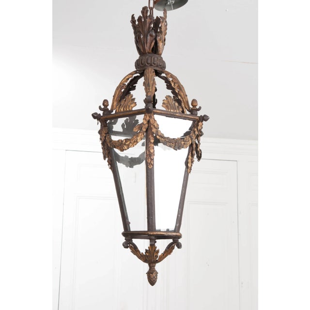 This French 19th century iron and gilt single-light lantern has been professionally rewired, now featuring a modern tube...