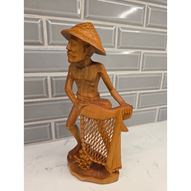 An exceptional, highly expressive mid-century Balinese modernist genre realism sculpture depicting a traditional...