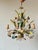 Vintage French polychrome tole chandelier dating from the 1960s. This five-light fixture is decorated with hand-formed...