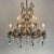 Gilded Iron and Crystal Chandelier, 15 lights on two levels, ten lower arms and five upper lights, curved double-volute...