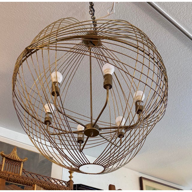 Design Plus Gallery presents the Chiron Collection Globe Chandelier from Mercana. Formed from metal in an antiqued gold...