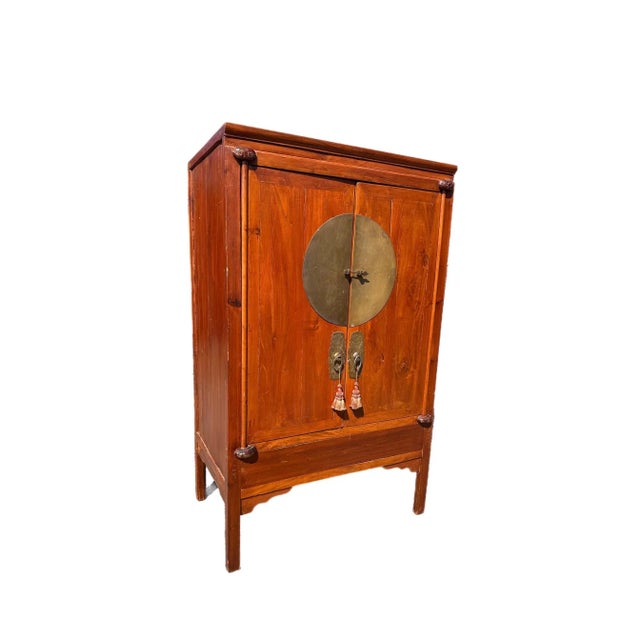 A 1890-1900's Chinese lacquered wedding cabinet/armoire , with brass detailing , tassels and a key inside two pull out...