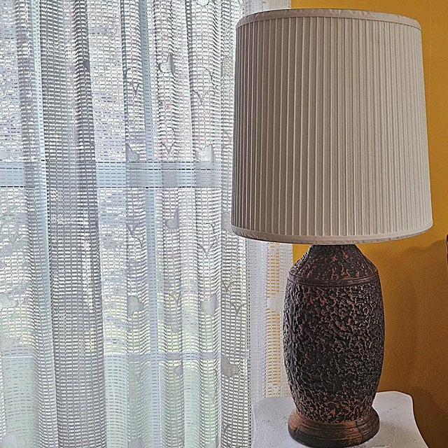 This striking vintage table lamp embodies 1970s Mediterranean Brutalist style, featuring a heavily textured pottery base...