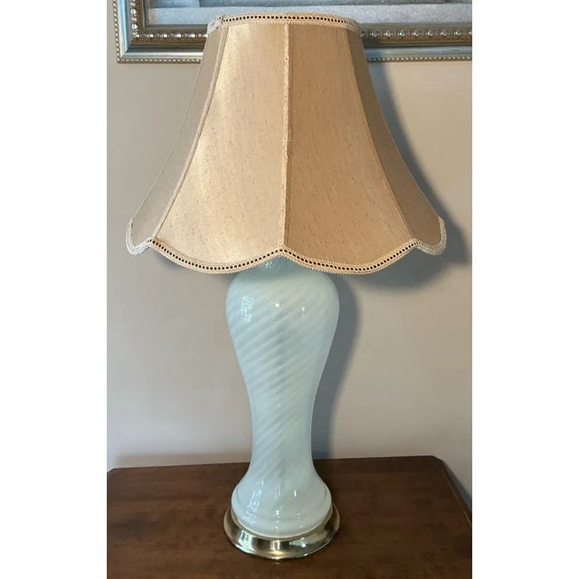 Elevate your space with this elegant pair of vintage Murano glass table lamps, circa 1960s–1970s, featuring a striking...