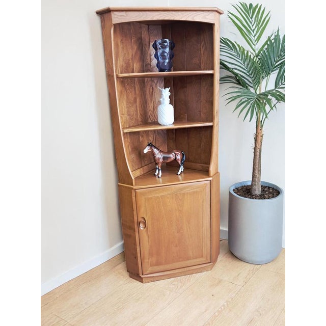 A truly elegant Ercol Windsor corner unit, designed by Lucian Ercolani and dating from the 1980s, presented here in...