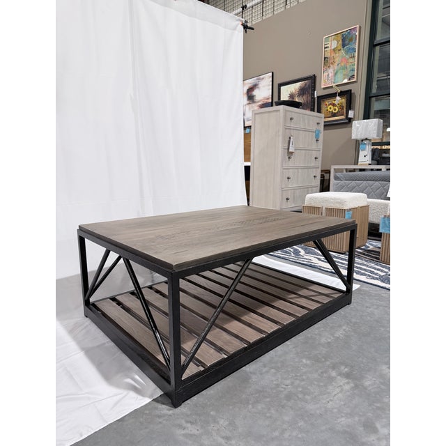 A striking Ethan Allen Beam coffee table designed with a bold industrial-modern profile and richly textured oak surfaces...