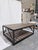 A striking Ethan Allen Beam coffee table designed with a bold industrial-modern profile and richly textured oak surfaces...
