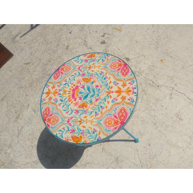 This is a metal pedestal base side table. The tile top makes it an indoor or outdoor table. The top has flowers and...