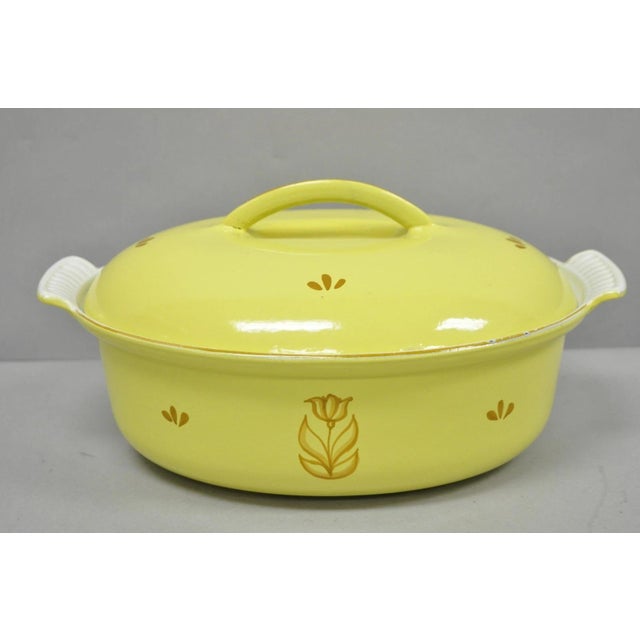 Vintage Dru Holland Yellow Tulip Enameled Cast Iron Dutch Oven Oval Pot. Circa Mid 20th Century. Measurements: 5" H x...