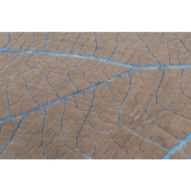 Hand-knotted in wool, this 10x8 modern abstract rug in beige-brown features a subtle high-low element married to the...