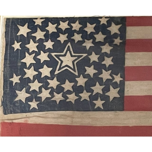 Paint-printed flag on cotton, 8 x 13 in. Double medallion pattern with haloed central star, flanked by three stars in each...