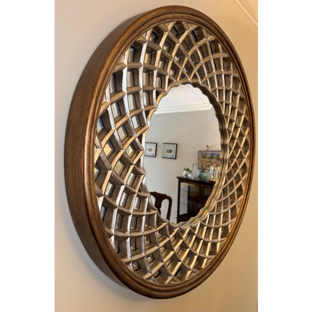 This sculptural 42-inch round lattice mirror features a refined blend of antique gold and soft silver, giving the frame...