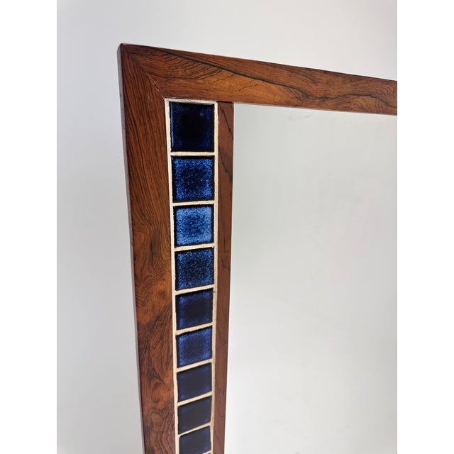 Rosewood mirror with inlaid blue ceramic tile. Attrib. Erik Worts (Denmark c. 1960s) Dimensions: H 45.75" x W 23.25"