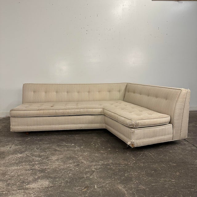 Angle sofa by Harvey Probber with cylindrical wood l legs. The current vintage upholstery is beige with yellow and white...
