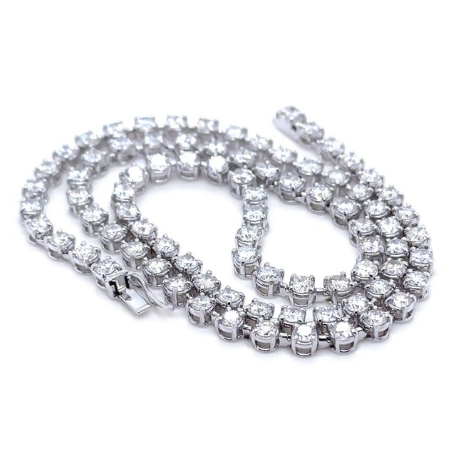 A timeless diamond necklace crafted in 18ct white gold, featuring an elegant line of round brilliant cut diamonds that...