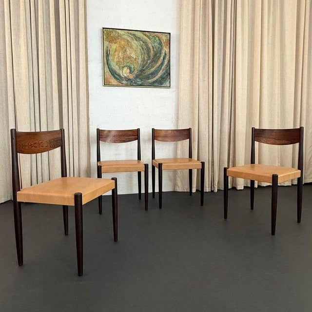 This set of four exceptional Danish modern, rosewood dining chairs were designed by Poul Volther and manufactured by Frem...