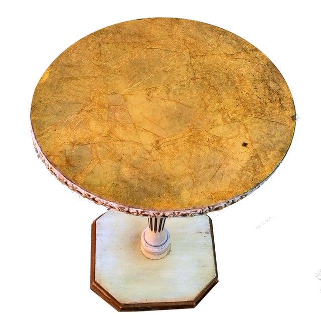 A beautiful Hollywood Regency style Italian hand painted gilt eglomise pedestal side table. The round table top is...