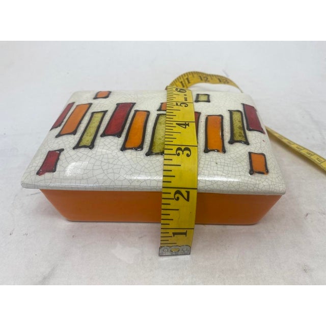 A striking vintage Italian ceramic covered box, designed for Raymor. This piece features a sophisticated Mid-Century...