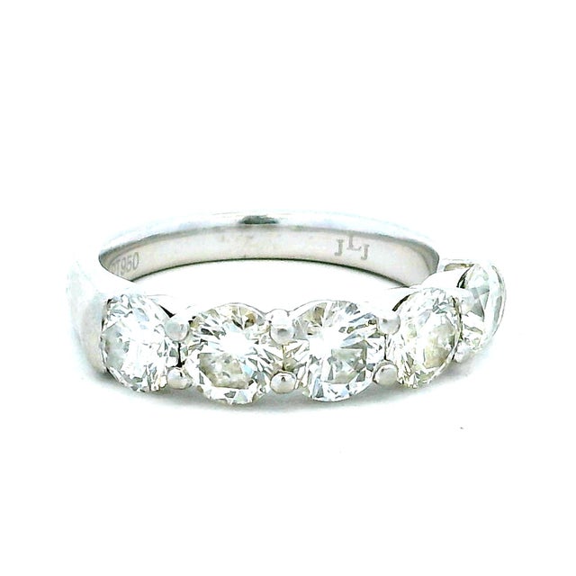 An elegant five-stone diamond band crafted in polished platinum and signed JLJ. Five round brilliant-cut diamonds graduate...