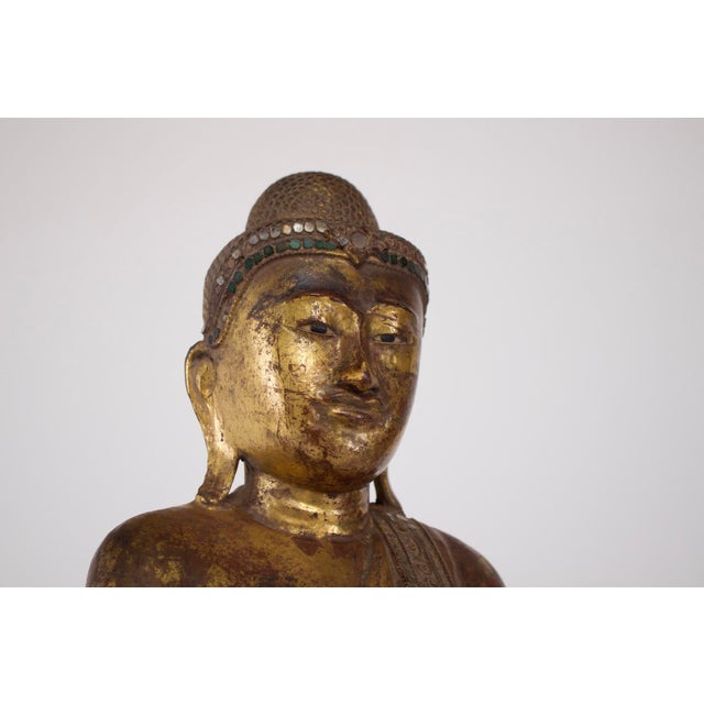 Standing buddha, carved from solid wood on a lotus-shaped base, burma, early mandalay period, mid-19th century. The...