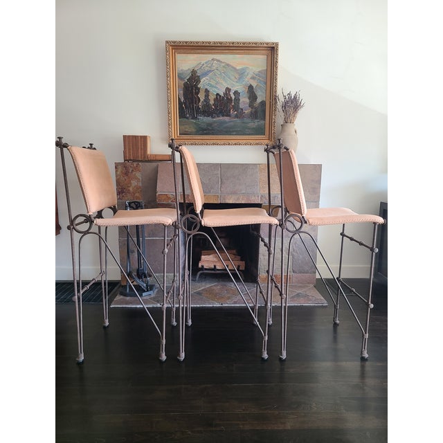Set of 3 iron stools in the style of Ilana Goor. Circa 1970's. Sculpted iron frame with hand-sewn leather seats and backs...
