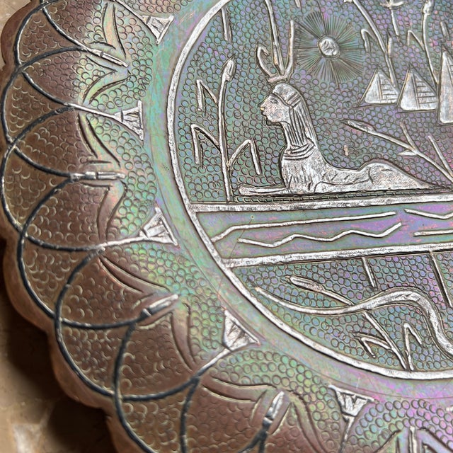 The surface is covered with finely detailed hieroglyphics, including the goddess Isis on her throne, a chariot and rider...