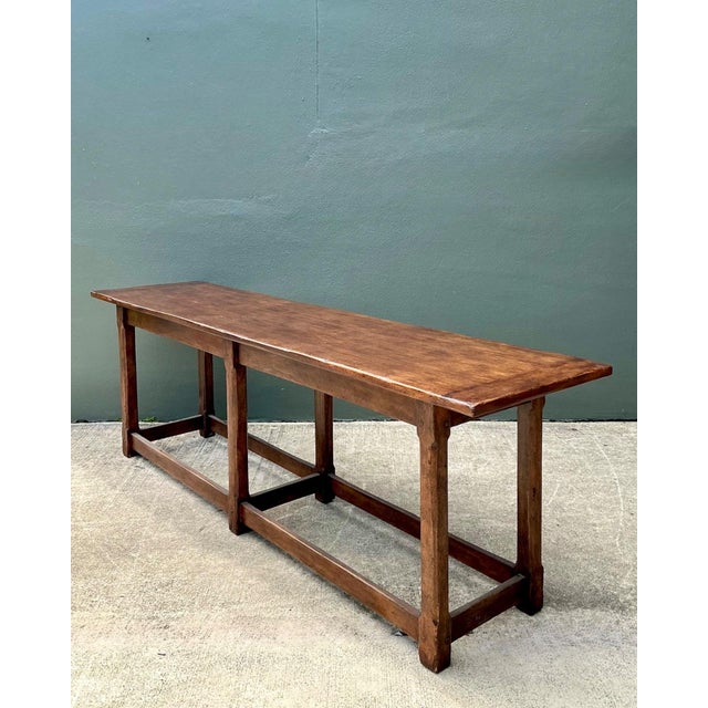 This vintage plank console table by Therien Studios embodies refined rustic elegance through its bold scale and honest...