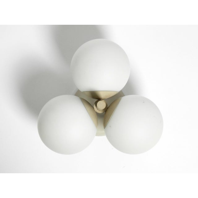 Metal ceiling lamp with 3 opal glass balls in typical space age light gray from kaiser leuchten. unusual sixties space age...