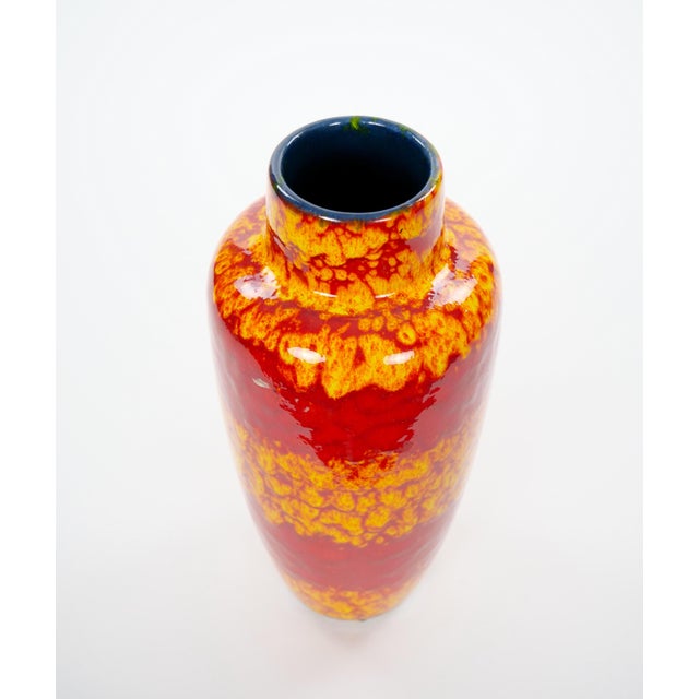 A striking mid-century West German glazed porcelain vase, beautifully showcasing the bold colors and modernist aesthetic...