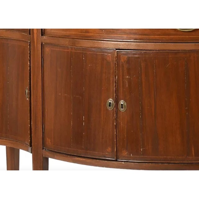 Federal Revival mahogany sideboard dating to the late 19th to early 20th century. The piece features a serpentine front,...