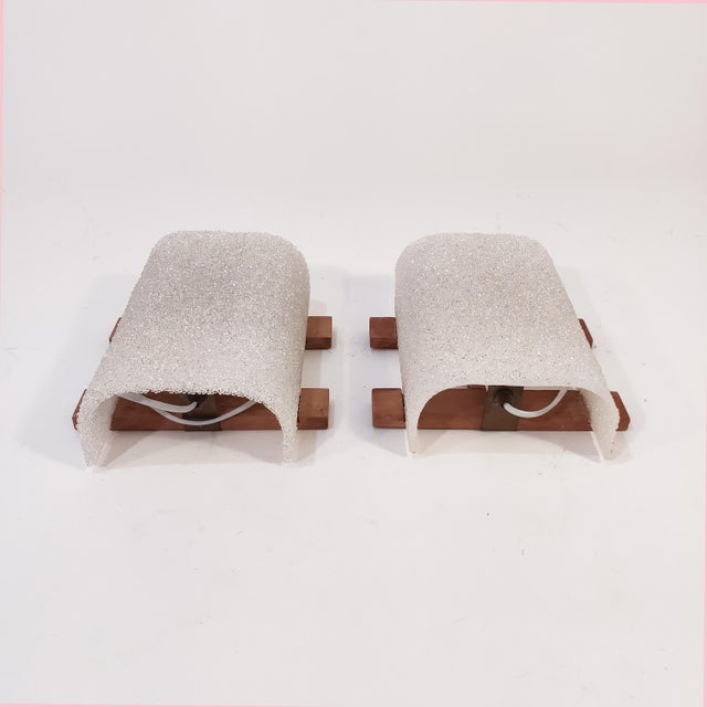 Pair of vintage Czech Drupol wall lights, 1960s. Wooden structure holding the granulated plastic lampshade, creating a...