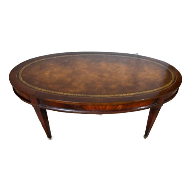 Vintage Regency Style Oval Leather Top Flame Mahogany Coffee Table on Casters. By Weiman. For Sale