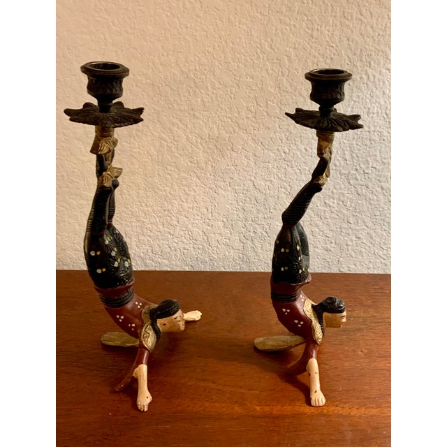 These items are vintage hand-painted cast iron Chinese acrobat candle holders. • They feature figures performing a...