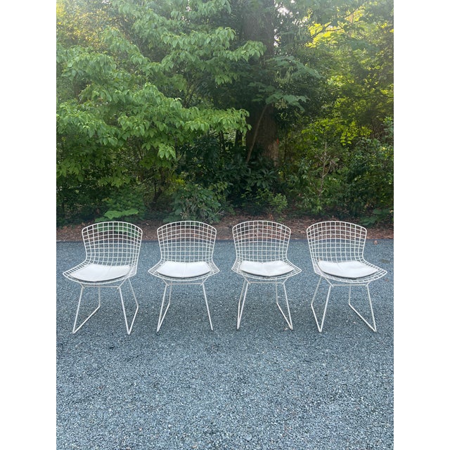 Elevate your indoor or outdoor living space with this exceptional, authentic set of four vintage wire side chairs,...
