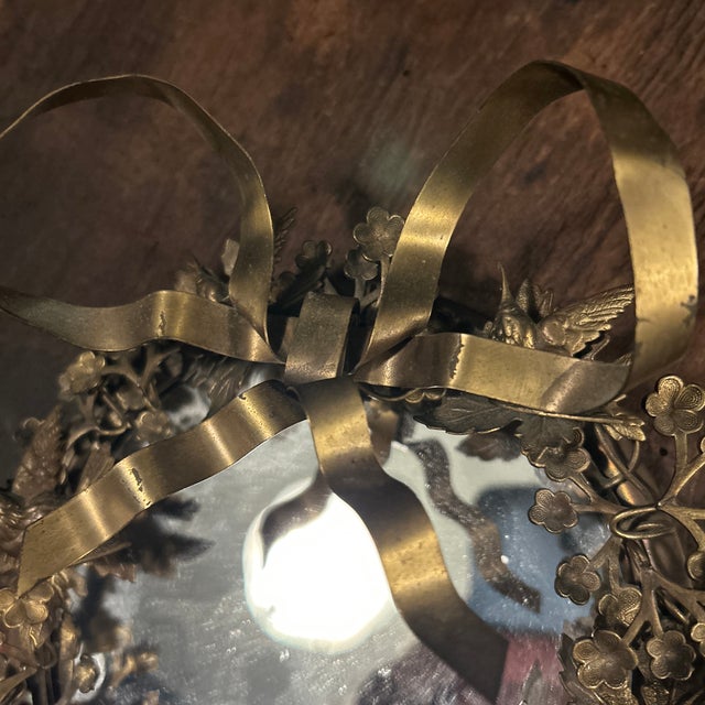 A rare and whimsical late 20th-century vintage Dresden-style brass wreath mirror by the American decor studio Petites...