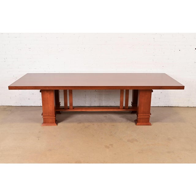 An exceptional Arts & Crafts style "Allen" dining table in natural cherry wood By Frank Lloyd Wright for Cassina Italy,...