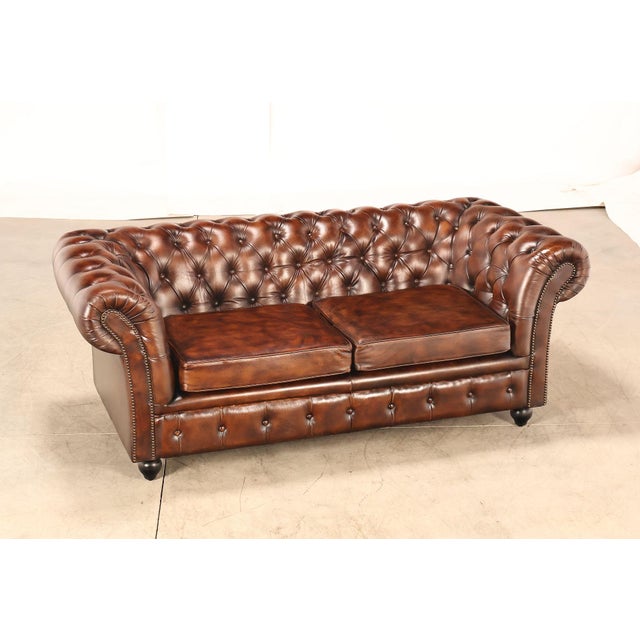 High Quality Tufted Brown Leather Chesterfield Sofa with Rolled Arms, Brass Nailhead Trim, and Turned Feet