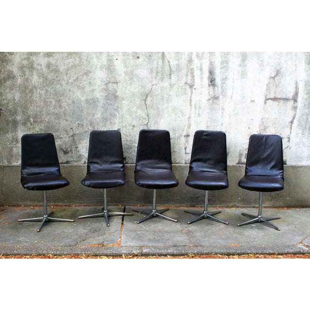 Genuine Eka chairs with a timeless design with their star-shaped chrome steel bases and space age-style black leather...