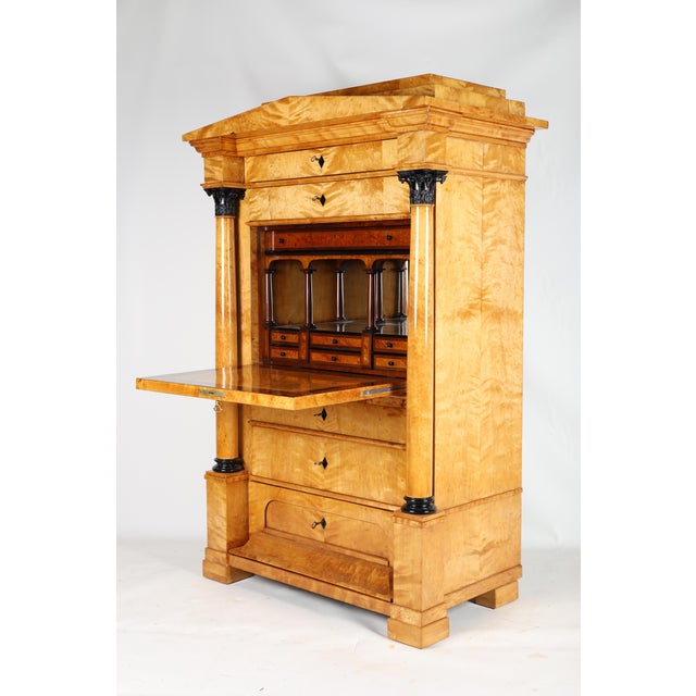 An impressive, architecturally very elegant secretary desk from the Biedermeier period. The pedestal features a pediment,...