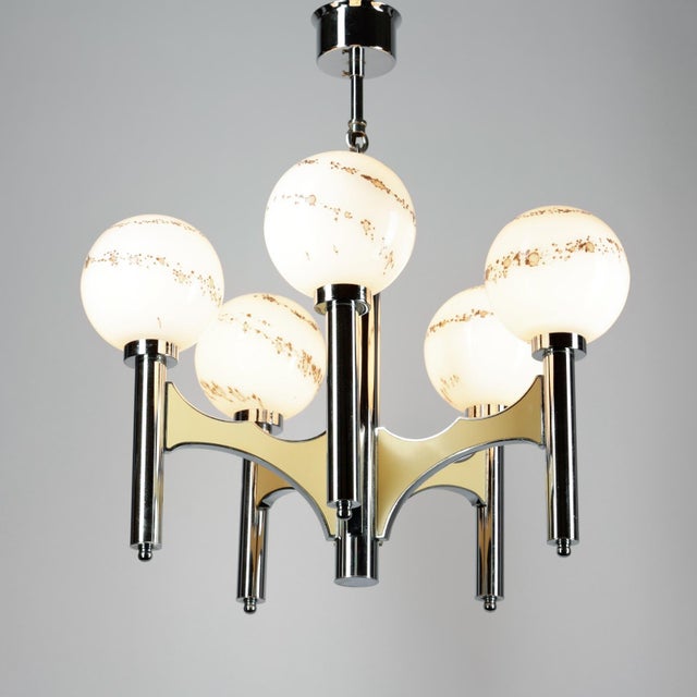 This impressive chandelier was designed by gaetano scolari in italy in the 1960s. An elegant fixture made of polished...